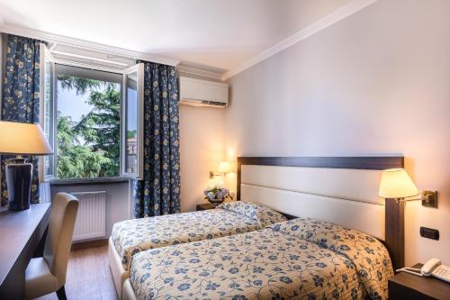 Postel nebo postele na pokoji v ubytování Hotel Dei Tigli