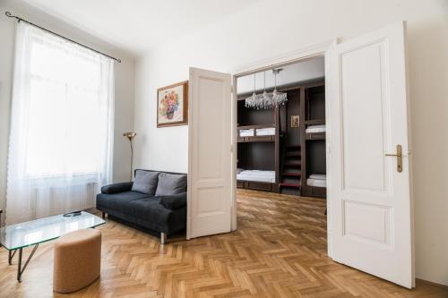 a living room with a couch and a open door at Vienna Boutique - Premium Hostel in Vienna
