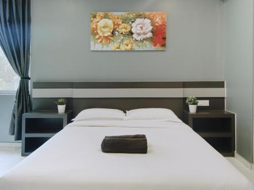 A bed or beds in a room at Hotel Eco Desaru