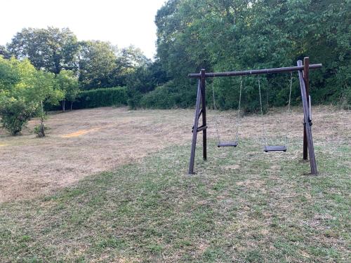an empty swing set in the middle of a field at Tenuta de Maffutiis in Polla