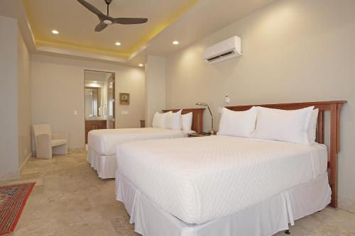 a hotel room with two beds with white sheets at Red Rock in St. George