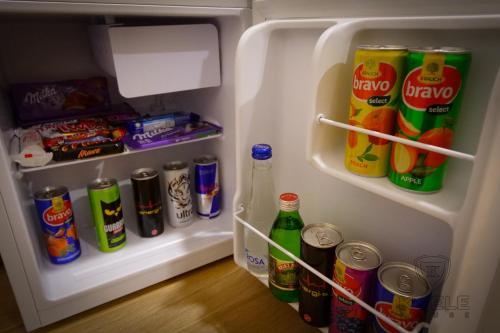 an open refrigerator filled with drinks and soda at Motel KVELE in Novi Pazar