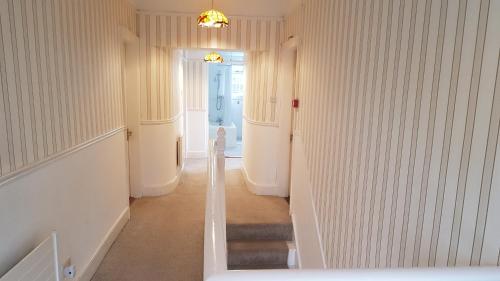 a hallway with a staircase in a house at Innisfree Guest House in Sligo