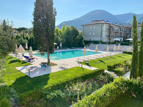 a swimming pool in a resort with a building at Luna27 in Toscolano Maderno