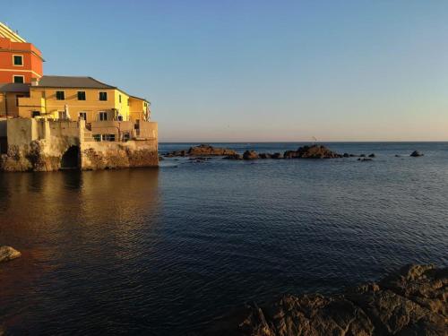 a view of the ocean with houses and buildings at IL RIFUGIO SUL MARE - GenovaInRelax in Genova