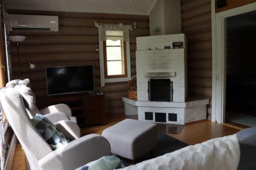 a living room with a couch and a fireplace at Levihaukka 10 in Sirkka