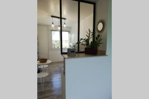 a living room with a table and a mirror at BEACH-CITY 3 PIECES in Saint-Raphaël
