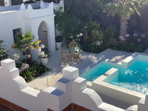 Kasbah Andaluz guest house في شيكلانا دي لا فرونتيرا: اطلالة جوية على حديقة مع مسبح