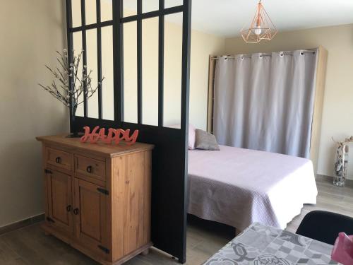 a small bedroom with a bed and a wooden cabinet at villa donia in Corte