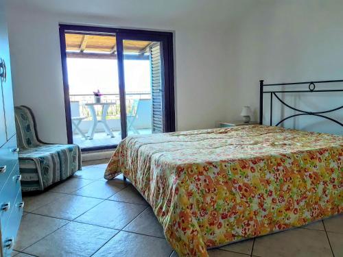 a bedroom with a bed and a view of a patio at Appartamenti Marina Maria in Murta Maria