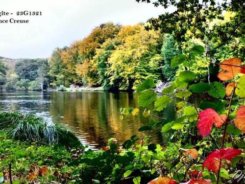 a view of a river with trees in the background at Gite Le Masgiral in Saint-Christophe