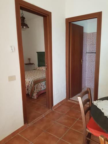 a room with a mirror and a table and a bed at dammuso rosa in Pantelleria