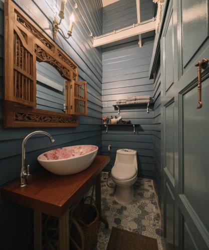 a bathroom with a sink and a toilet at Lhong Yaowarat hostel in Bangkok