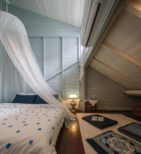 a bedroom with a bed with a mosquito net at Lhong Yaowarat hostel in Bangkok