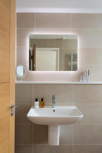 a bathroom with a sink and a mirror at 12 Pear Tree House in York