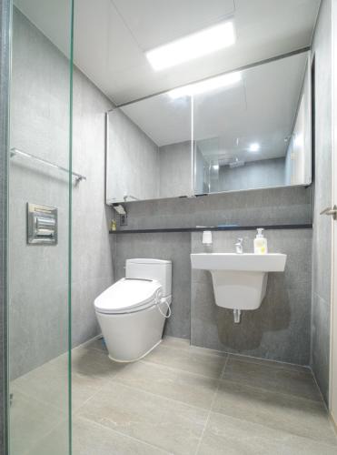 a bathroom with a toilet and a sink at Sokcho Daemyung Pension Samsung Home prestige in Sokcho