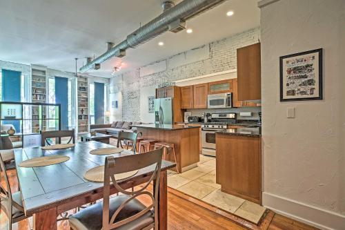 a large kitchen with a table and some chairs at Walk to Dtwn Distilleries Nulu Art District Loft in Louisville