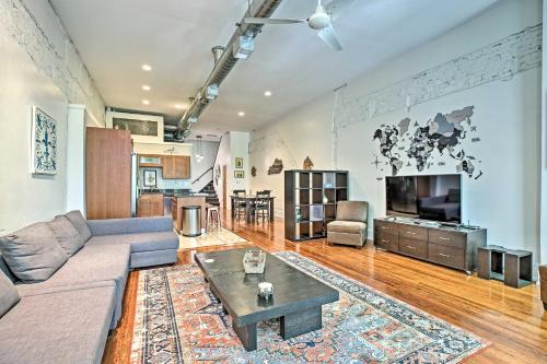 a living room with a couch and a coffee table at Walk to Dtwn Distilleries Nulu Art District Loft in Louisville
