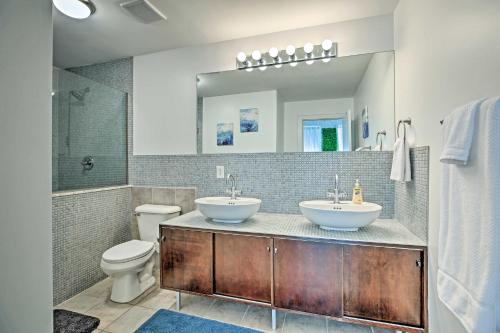 a bathroom with two sinks and a toilet at Nulu Art District Loft Walk to Dtwn Distilleries! in Louisville