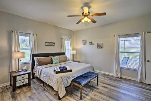 a bedroom with a bed and a ceiling fan at Modern Home with Patio and Grill in Cape Coral! in Cape Coral