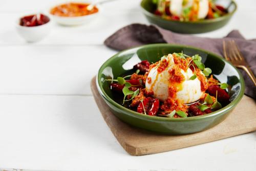 a green bowl of salad with an egg on top at Holiday Inn - Leicester - Wigston by IHG in Leicester