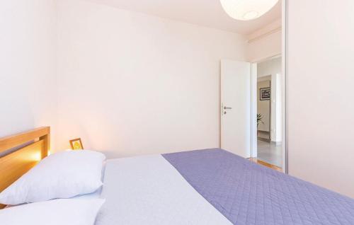 a white bedroom with a bed and a mirror at Big White apartment in Novi Vinodolski