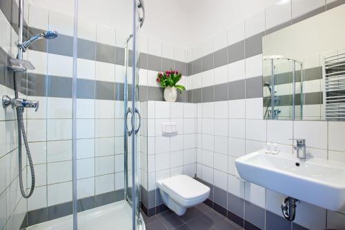 a bathroom with a toilet and a sink and a shower at Laguna in Świnoujście