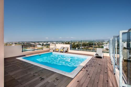 a swimming pool on the roof of a building at Alegria Amazing apartment with swimming pool in Olhão
