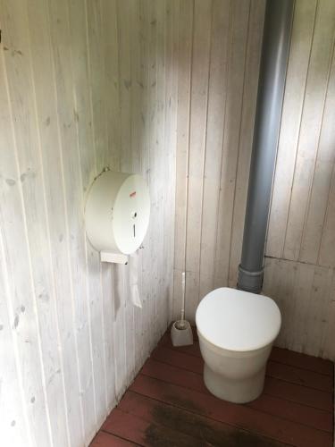 a bathroom with a white toilet in a room at Vandrarhem Svänö in Hillerstorp