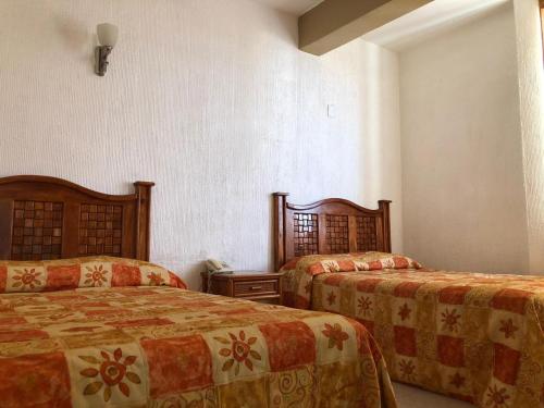 Tempat tidur dalam kamar di Hotel Sol del Pacifico