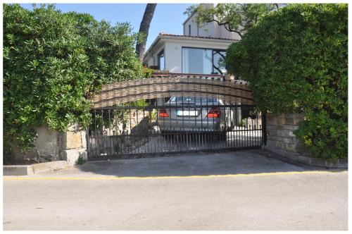 a brick fence with a gate in front of a house at Premium apartment Natura in Izola