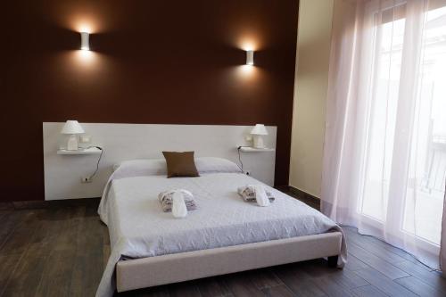 a bedroom with a bed with two towels on it at B&B Leus Appartment in Reggio Calabria