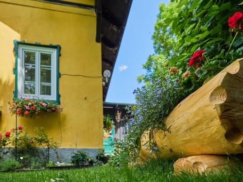 a building with a window and flowers in front of it at Ferienhaus Krieglach in Krieglach