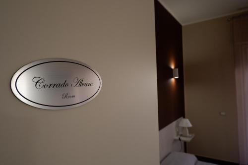 a bathroom with a sign on a wall next to a toilet at B&B Leus Appartment in Reggio Calabria
