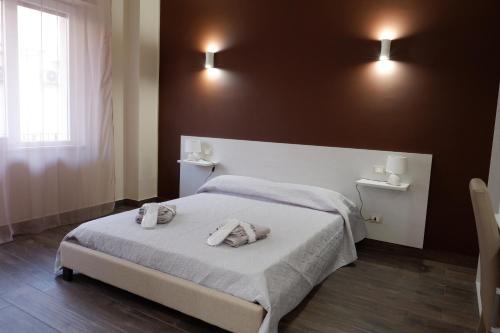 a bedroom with a bed with two towels on it at B&B Leus Appartment in Reggio Calabria