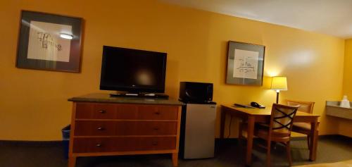 a room with a dresser with a television on top of it at Olympic View Inn in Sequim