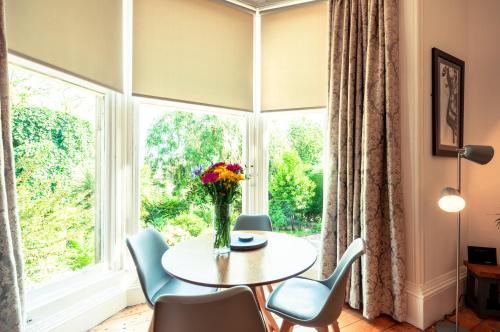 a dining room with a table and chairs and a window at House on the hill in Dundee