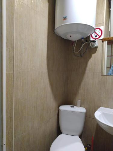 a bathroom with a white toilet and a sink at 1 комн квартира, свой двор in Cherkasy