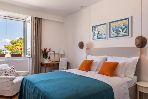 a bedroom with a blue and white bed and a window at Promenade Room Split **** in Split