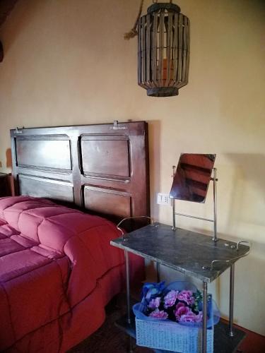 a room with a bed and a table in a room at La Giuncaia in Pieve Santo Stefano