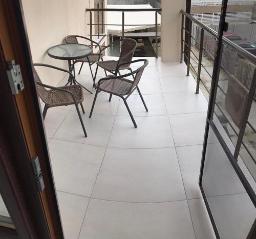 a balcony with chairs and a table and a table at Villa San-Marina in Zatoka