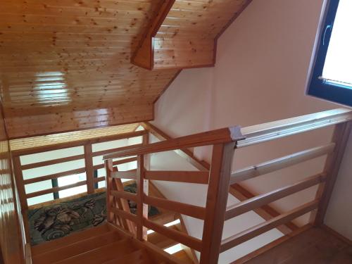 a staircase in a house with wooden ceilings at CABANA DORULUI in Tău Bistra