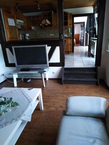 a living room with a tv and a couch at Fachwerkhaus in D 63667 Nidda für 8 bis 12 Personen in Nidda