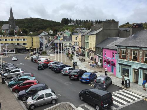 a town with a lot of cars parked on the street at Apartment 8, Clifden Bay Apartments in Clifden