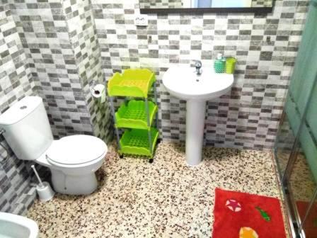 a bathroom with a toilet and a sink at Torrevieja Playa Cura in Torrevieja