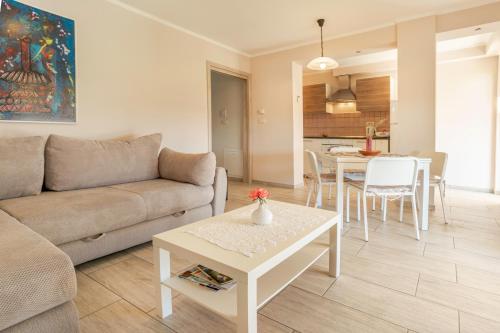 a living room with a couch and a table at Apartments Apartim Piran in Piran