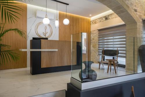 a glass display case in a room with a chair at Casa D'Irene Deluxe Hotel in Falasarna