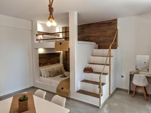 a small apartment with a loft bed and a living room at Home Sweet Home in Ammoudia