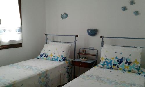 ヴィッラシミーウスにあるCasa Signorileのベッドルーム1室(ベッド2台、窓付)