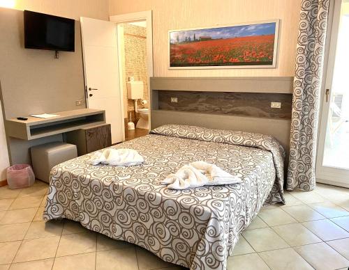 Postel nebo postele na pokoji v ubytování Hotel Amico